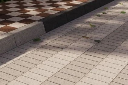 Pavimento de adocreto rectangular gris y marrón en una plaza pública. Adocreto Holland.