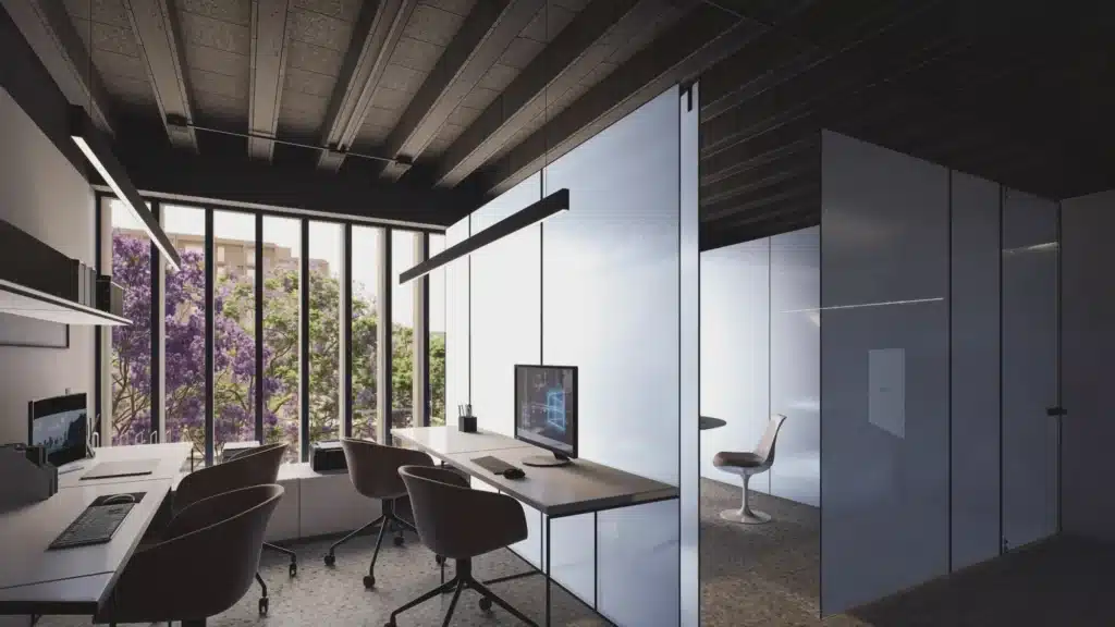 Oficinas modernas con muros aparentes y grandes ventanas. Espacios de trabajo luminosos.